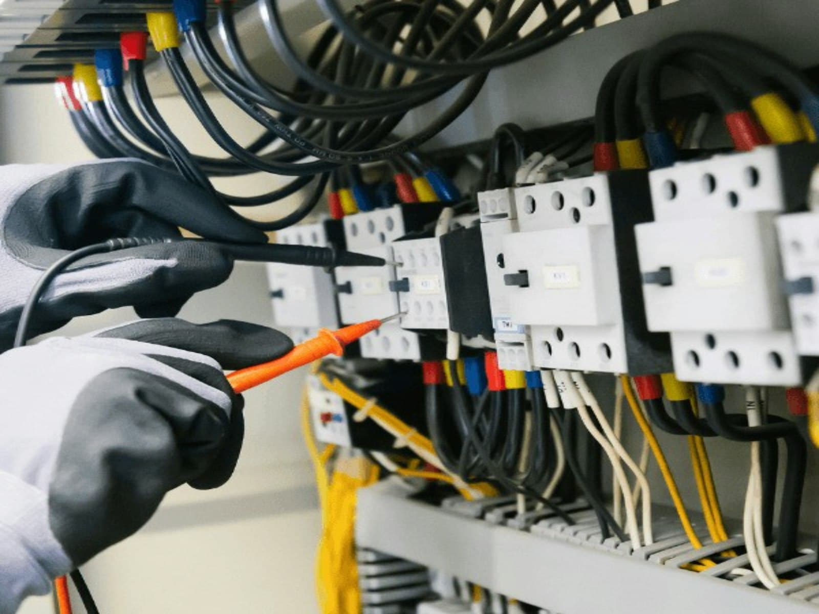 EPS technician servicing electrical control panel
